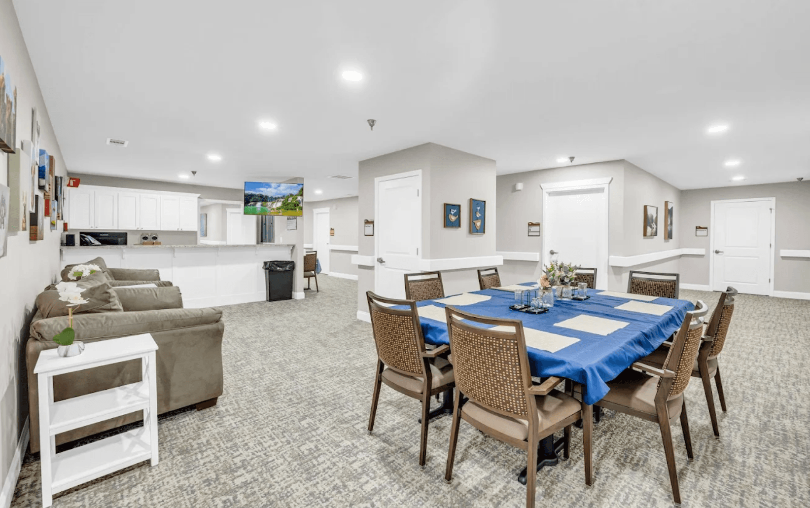 Residents and staff around the shared dining table at Joy
